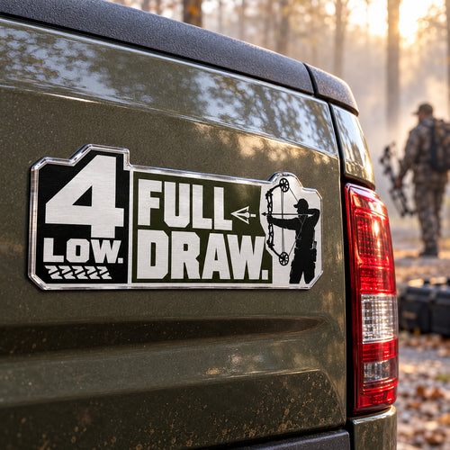 4 Low Full Draw compound bow metal car emblem on a pickup truck tailgate, angle view