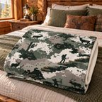 Pixel Field Elk Fleece Blanket folded on a bed