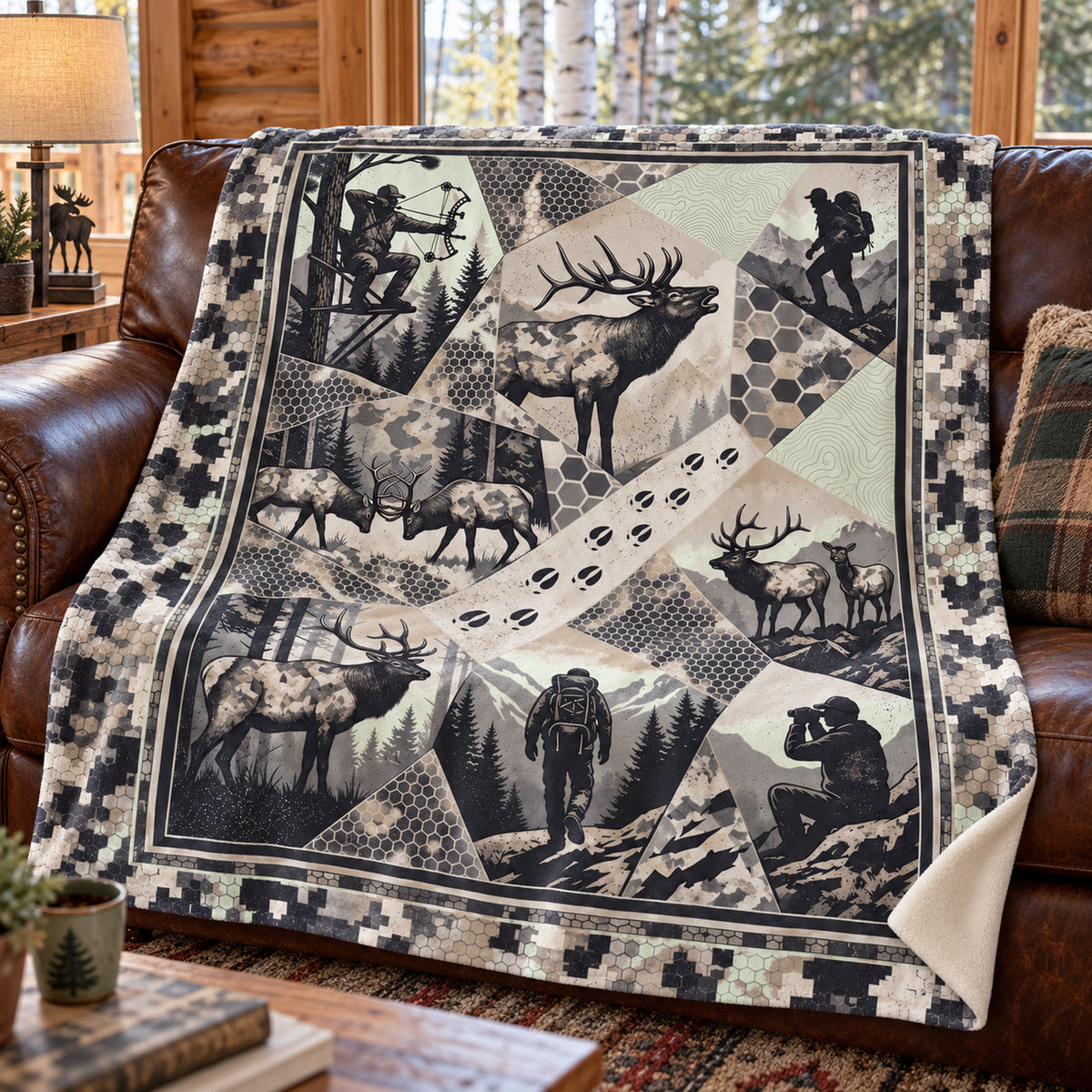 Greyscale elk herd patchwork fleece blanket draped over a cabin couch