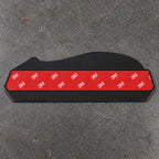 Back of the emblem: black ABS backing plate with pre-applied 3M adhesive