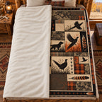 Blanket folded back on a bed, showing the sherpa lining