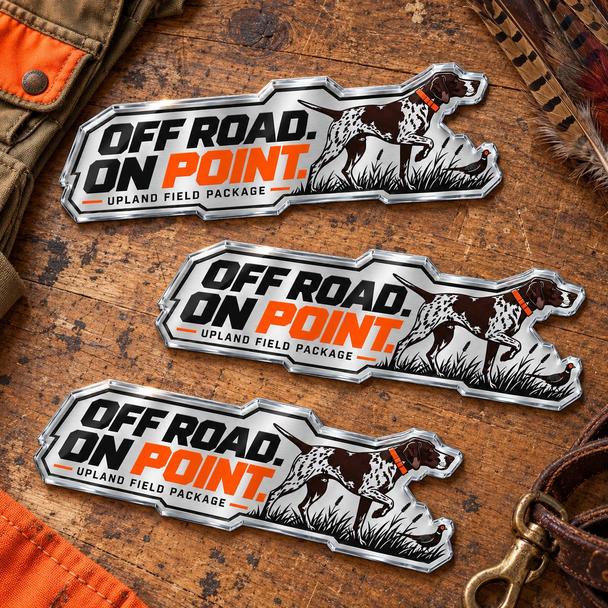 Three sizes of the upland pointer metal emblem side by side